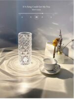 The rose-shaped crystal lamp illuminating a bedside table in a bedroom setting, creating a warm and inviting atmosphere.