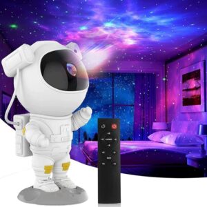 The astronaut night light projector displaying a mesmerizing pink and purple nebula projection on a bedroom ceiling.