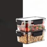 "Set of two 300ml plastic food storage containers with airtight lids. Two stacked 300ml food storage containers filled with colorful salad, showcasing stackable design and portion size. Open 300ml food storage container with a transparent design revealing fresh fruit inside. "