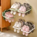 Plastic hanging shoe rack with multiple compartments for storing shoes. Space-saving shoe organizer with hooks for hanging over doors or closet rods. Hanging shoe rack made from durable plastic for easy storage and access.