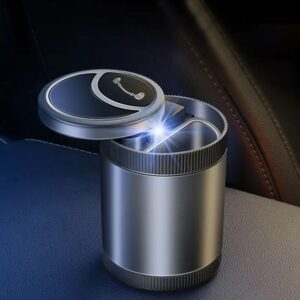 "Automatic ashtray with a cool blue LED light, displayed closed in a car cup holder. Person flicking cigarette ash into the open automatic ashtray with a blue LED light inside a car. Close-up of the automatic ashtray with a blue LED light, highlighting its sleek design and compact size."