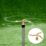 Automatic rotating copper sprinkler for even watering of lawns and gardens. Copper sprinkler with rotating arms for watering plants on patios or balconies.