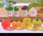 Pack of four colorful, glow-in-the-dark vegetable miniature toys. Set of four luminous plastic vegetable toys for children. Fun and educational vegetable toys that glow in the dark.