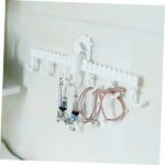 White plastic multipurpose hook hanger with multiple hooks, ideal for various items. White multipurpose hook hanger mounted on a wall, holding a coat and a bag. Close-up of a white multipurpose hook hanger with smooth, plastic surface.