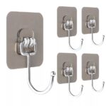 "Close-up of multiple metal sticker hooks in various colors (depending on availability) adhered to a smooth wall. Person hanging a lightweight bag on a metal sticker hook attached to a kitchen cabinet door. Package containing 10 metal sticker hooks in different colors, highlighting the variety included."