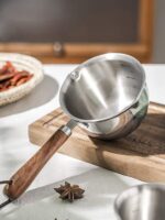 A close-up image of the saucepan's interior, emphasizing the smooth and polished stainless steel surface for easy cleaning and maintenance. The image may also highlight capacity markings etched on the interior, providing a helpful guide for measuring ingredients.