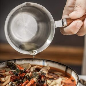 A close-up image of the saucepan's interior, emphasizing the smooth and polished stainless steel surface for easy cleaning and maintenance. The image may also highlight capacity markings etched on the interior, providing a helpful guide for measuring ingredients.