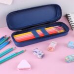 The cartoon-printed pencil pouch open, showcasing the storage capacity and any compartments