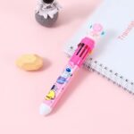 A close-up image focusing on the details of the pen. Mention the click mechanism for easy ink color selection and if the 10 colored pen tips are visible. Describe any interesting details of the astronaut design on the pen.