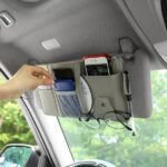 A car sun visor organizer made of PU leather It features multiple compartments for storing various car essentials.