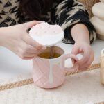 This image showcases a charming ceramic coffee mug featuring a delightful biscuit pattern. The playful design adds a touch of whimsy to your morning routine, making it perfect for coffee, tea, or any hot beverage.